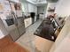 Kitchen with stainless steel appliances, granite counters and white cabinets open to dining area at 5736 Colonial Dr, New Port Richey, FL 34653
