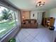 Inviting sunroom with large windows, tiled floor, and a comfortable seating area with a view of the backyard at 5736 Colonial Dr, New Port Richey, FL 34653