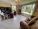 Comfortable bonus room with recliner, desk and bright windows overlooking the backyard at 5736 Colonial Dr, New Port Richey, FL 34653