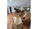 Open concept living room with wood floors, comfortable seating, and seamless flow to the kitchen and dining area at 5736 Colonial Dr, New Port Richey, FL 34653