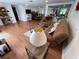 Spacious living room with wood floors, comfortable seating, and an open layout to the kitchen and dining areas at 5736 Colonial Dr, New Port Richey, FL 34653