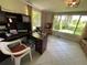 Bright office featuring a desk, large windows overlooking the yard, and tile flooring at 5736 Colonial Dr, New Port Richey, FL 34653