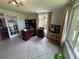 Sunlit office offers ample workspace, large windows with backyard views, and tiled floors at 5736 Colonial Dr, New Port Richey, FL 34653