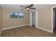Comfortable bedroom with ceiling fan, closet, and window view at 6206 11Th Ave, New Port Richey, FL 34653