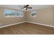 Spacious bedroom with large windows and ceiling fan at 6206 11Th Ave, New Port Richey, FL 34653