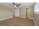 Bedroom boasts wood floors, ceiling fan, closet, and views of the ensuite bathroom and shower at 6206 11Th Ave, New Port Richey, FL 34653