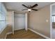 Bright bedroom with hardwood floors, ceiling fan, and closet for ample storage at 6206 11Th Ave, New Port Richey, FL 34653