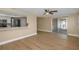 Bright and airy living area with wood floors and an open layout with views to kitchen at 6206 11Th Ave, New Port Richey, FL 34653
