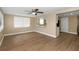 Open-concept living area with wood floors, a ceiling fan, and access to the kitchen at 6206 11Th Ave, New Port Richey, FL 34653