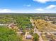 Stunning aerial view of lush landscape and property featuring mature trees, open fields, and nearby homes at 6418 E 23Rd Ave, Tampa, FL 33619