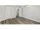 Bedroom featuring vinyl flooring, a closet, mini split AC and neutral colored walls at 6418 E 23Rd Ave, Tampa, FL 33619