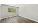 A compact bedroom with a view, vinyl floors, and a neutral color scheme at 6418 E 23Rd Ave, Tampa, FL 33619