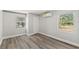 A bright bedroom with two large windows, vinyl flooring and mini split air conditioner at 6418 E 23Rd Ave, Tampa, FL 33619