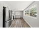 Updated kitchen with stainless steel appliances, white cabinets, and bright natural light at 6418 E 23Rd Ave, Tampa, FL 33619