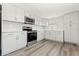 Bright kitchen with stainless steel oven and microwave, white cabinets, and sleek countertops at 6418 E 23Rd Ave, Tampa, FL 33619