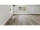 A sunlit living room showcasing durable vinyl floors and neutral paint, ready for personalization at 6418 E 23Rd Ave, Tampa, FL 33619