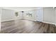 Bright living room featuring modern gray vinyl flooring and natural light from multiple windows at 6418 E 23Rd Ave, Tampa, FL 33619