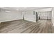 Open-concept living room featuring modern gray flooring that seamlessly connects to the kitchen at 6418 E 23Rd Ave, Tampa, FL 33619