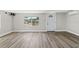 Bright living room with a large window, and updated flooring at 6418 E 23Rd Ave, Tampa, FL 33619