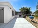 A backyard featuring a concrete patio, screened area, and a small grill at 6431 Gainsboro Dr, Port Richey, FL 34668