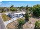 Aerial view of backyard featuring a concrete patio, fenced yard, and mature landscaping at 6431 Gainsboro Dr, Port Richey, FL 34668