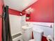 Cozy red-walled bathroom featuring a shower and white vanity with sink at 6431 Gainsboro Dr, Port Richey, FL 34668