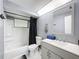 Functional bathroom with a shower-tub combo, updated vanity, and bright lighting at 6431 Gainsboro Dr, Port Richey, FL 34668