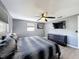 Cozy bedroom with gray walls, ceiling fan, dresser, and large bed perfect for relaxation at 6431 Gainsboro Dr, Port Richey, FL 34668