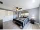 Comfortable bedroom with a ceiling fan, closet, and two bedside tables at 6431 Gainsboro Dr, Port Richey, FL 34668