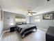 Comfortable bedroom with soft natural light, ceiling fan, grey walls, and modern decor at 6431 Gainsboro Dr, Port Richey, FL 34668