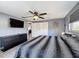 Cozy bedroom with TV, dresser, closet, and a comfortable bed, offering a relaxing space at 6431 Gainsboro Dr, Port Richey, FL 34668