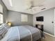 Comfortable bedroom featuring a ceiling fan, mounted TV, and plenty of natural light at 6431 Gainsboro Dr, Port Richey, FL 34668
