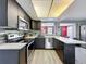 Well-equipped kitchen featuring dark cabinets, stainless appliances, and bar seating for casual dining at 6431 Gainsboro Dr, Port Richey, FL 34668