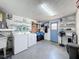 Functional laundry room with washer, dryer, and ample storage shelves at 6431 Gainsboro Dr, Port Richey, FL 34668
