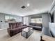 Inviting living room with neutral tones, stylish furniture, and a view of the front yard at 6431 Gainsboro Dr, Port Richey, FL 34668