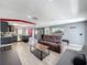 Open-concept living space with laminate flooring, comfortable seating, and access to the kitchen at 6431 Gainsboro Dr, Port Richey, FL 34668