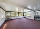 Spacious sunroom with windows and carpeting, offering a versatile living space at 6431 Gainsboro Dr, Port Richey, FL 34668