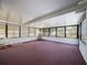 Bright sunroom with multiple windows and carpeted floor, ideal for relaxation at 6431 Gainsboro Dr, Port Richey, FL 34668