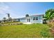 View of backyard of home with lush lawn and blue siding at 6432 Boatyard Dr, Hudson, FL 34667