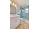 Modern bathroom features a stylish vanity, a framed mirror, and glass enclosed shower at 6432 Boatyard Dr, Hudson, FL 34667
