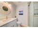 Bathroom with white vanity, elegant mirror, toilet, and modern shower at 6432 Boatyard Dr, Hudson, FL 34667