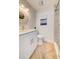 Bright bathroom with modern vanity, decorative mirror, and a glass-enclosed shower with stylish gray-tone tiling at 6432 Boatyard Dr, Hudson, FL 34667