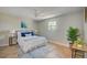Serene bedroom featuring a ceiling fan, herringbone floors, a window and a comfortable bed with stylish decor at 6432 Boatyard Dr, Hudson, FL 34667