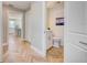 Hallway featuring herringbone wood floors leading to a half-bathroom and kitchen at 6432 Boatyard Dr, Hudson, FL 34667