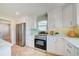 Bright kitchen features stainless steel appliances, white cabinets, and a tiled backsplash at 6432 Boatyard Dr, Hudson, FL 34667