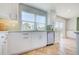 Bright kitchen with stainless steel appliances, Herringbone floors, and a large sink overlooking the backyard at 6432 Boatyard Dr, Hudson, FL 34667