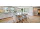 Bright kitchen boasts a large marble island, modern cabinetry, and views of the canal at 6432 Boatyard Dr, Hudson, FL 34667