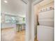 View of the open kitchen from the laundry room with a stacked washer and dryer set for easy access at 6432 Boatyard Dr, Hudson, FL 34667