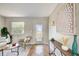 Bright living room with a decorative rug, console, and light herringbone floors at 6432 Boatyard Dr, Hudson, FL 34667