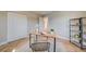 Bright office space with herringbone floors, a large closet, a wooden desk, and a stylish shelving unit at 6432 Boatyard Dr, Hudson, FL 34667
